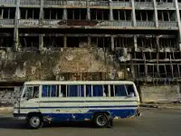 A bus drives past a hotel destroyed during the war in downtown Khartoum, Sudan