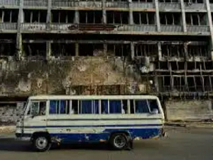 A bus drives past a hotel destroyed during the war in downtown Khartoum, Sudan