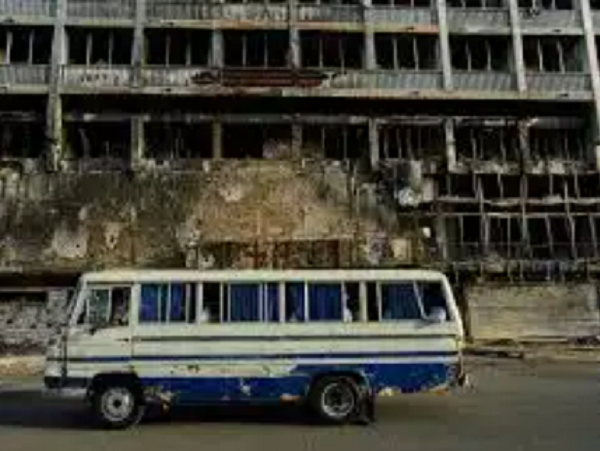 A bus drives past a hotel destroyed during the war in downtown Khartoum, Sudan
