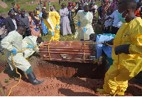 Relatives weep as they attend the burial  of Neema Minaro, a 66 year old woman who died of ebola