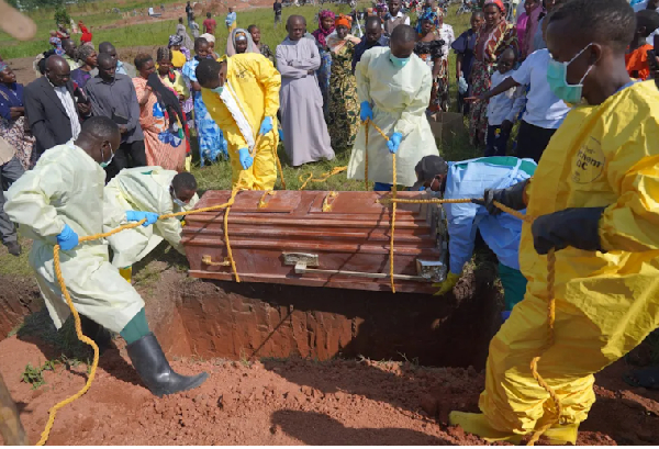 Relatives weep as they attend the burial  of Neema Minaro, a 66 year old woman who died of ebola