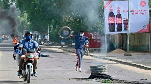 Demonstrators burn tyres during clashes with Chadian police in N'Djamena on April 27, 2021