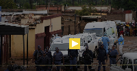 South African police gather at the scene of a mass shooting where gunmen killed nine