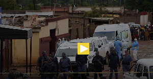 South African police gather at the scene of a mass shooting where gunmen killed nine