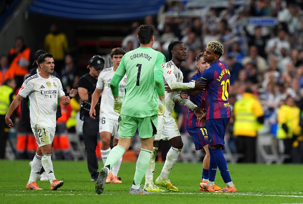 Lamine Yamal (in bleached hair) surrounded by Real Madrid players after the game