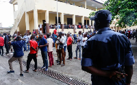 People wait to cast their votes on Saturday outside a school used as a polling station