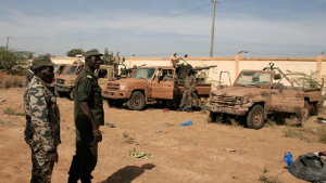 Malian soldiers inspect armed vehicles recovered from Islamist militants during fighting