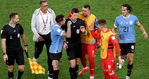 Uruguay players attack referee Daniel Siebert