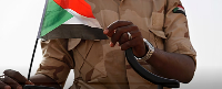 A Sudanese soldier from the Rapid Support Forces stands on his vehicle in the East Nile