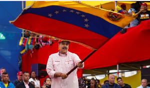 Venezuela's President Nicolas Maduro waves a flag during an event