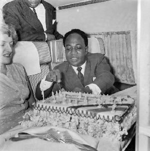 The image shows Nkrumah in a joyful mood, surrounded by companions