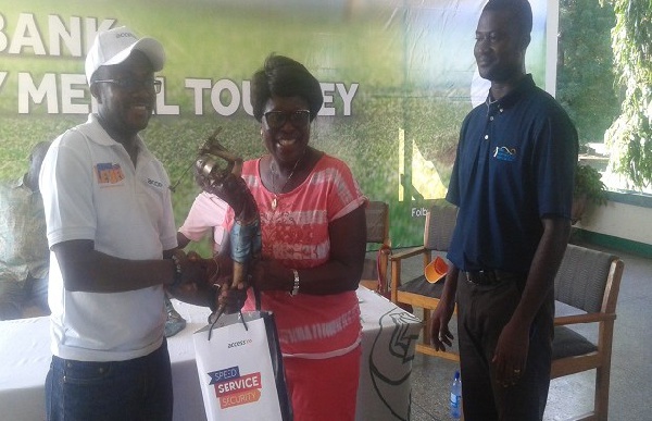 Lady Capo (middle) receiving her prize from an official of Access