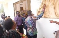 Rev Dr Mensa Otabil unveiling the plaque whilst Prof Yankah and others looks on