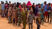 Internally displaced Somali children gather outside their makeshift shelters