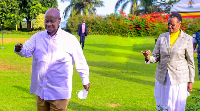 Ugandan President Yoweri Museveni [L] is cheered on by his wife
