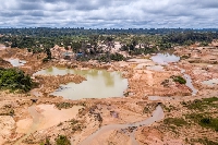 Aerial view of deforested area of Amazon rainforest caused by illegal mining activities in Brazil