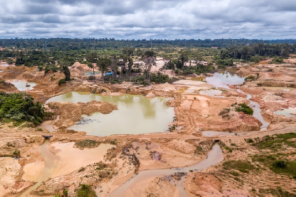 Aerial view of deforested area of Amazon rainforest caused by illegal mining activities in Brazil