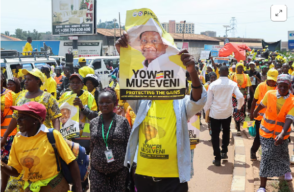 [1/5]Supporters of Uganda's President and the leader of ruling NRM party march along the streets