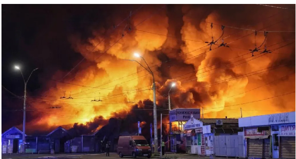 Firefighters work at the site of a book market hit by a Russian missile strike in Kyiv