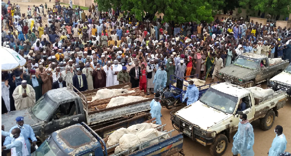 Trucks carry the wrapped bodies of people killed by suspected Boko Haram militants