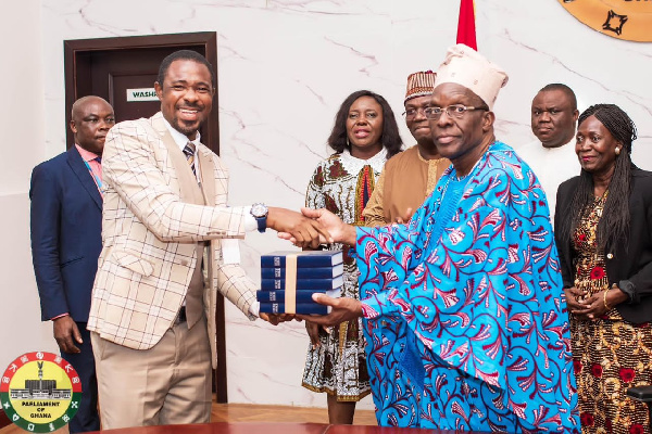 Speaker Alban Bagbin receiving the Bibles