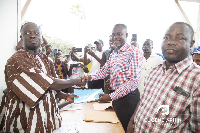 Eugene Arhin handing over his forms