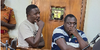 Two advocates, Bob Mwanjuzi and Lawrence Kalamu, appear in the dock in court