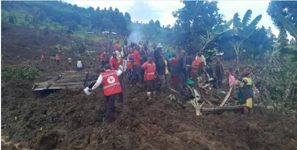 Rescue workers try to save survivors buried in the landslide