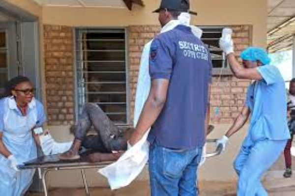 Hospital workers carry an injured man at Bukavu Provincial Hospital in Bukavu after two explosions
