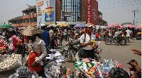 Street vendors sell goods at a road intersection in Port Harcourt, Rivers state, Nigeria