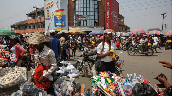 Street vendors sell goods at a road intersection in Port Harcourt, Rivers state, Nigeria