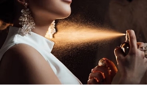 File photo: A young lady spraying perfume on her skin