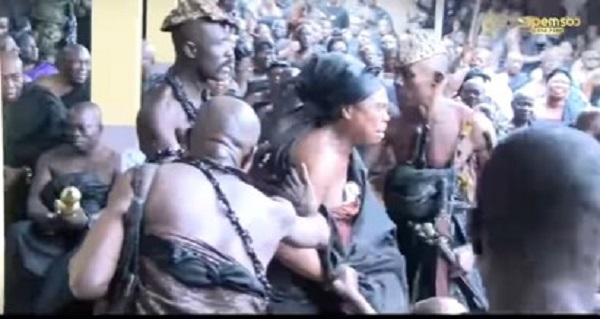 The queen mother weeping as she is being escorted by Otumfuo's security guards