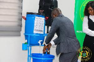Minister of Health, Kwabena Mintah Akandoh observing personal hygiene