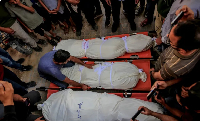 The bodies of Palestinians who lost their lives in Israeli air strikes are seen during a funeral