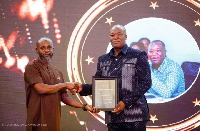 Country Manager of Rainbow Agrosciences Limited, David Oware Ansong receiving the plaque