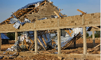 Many houses were destroyed, while four public school buildings had their roofs ripped off.