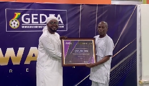 Abdul Hayye Yartey receives the award from Reverend Osei Kofi