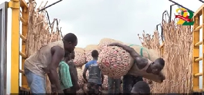 File photo of men offloading sacks of onion
