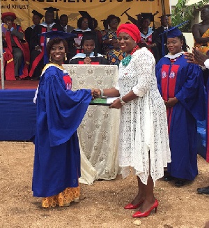 The UCOMS Best Female Student receiving her award from Ms Obuobia Darko-Opoku