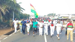 Chief of Staff, Julius Debrah [Holding flag] on campaign tour of the Volta Region