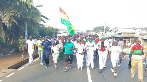 Chief of Staff, Julius Debrah [Holding flag] on campaign tour of the Volta Region