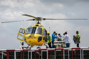 Medics and rescuers transfer mountaineer Dawa Sherpa from helicopter upon his arrival at a hospital