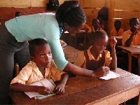 A female teacher in class with her students