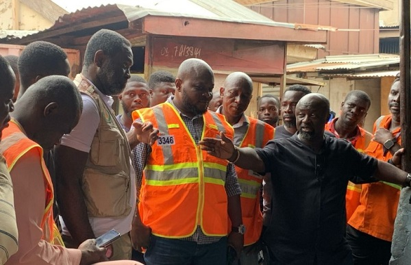 Ahmed-Rufai Afarahim, Deputy Dir. General of NADMO speaks to reclamation team and fire victims