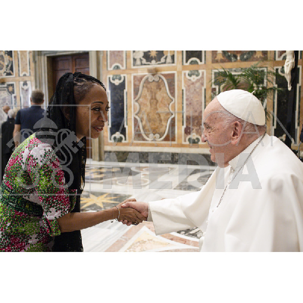 Samia Nkrumah in a handshake with Pope Francis