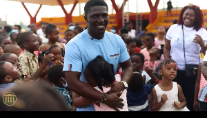 Dr Michael Boadi Nyamekye embraces children at the opening of The Maker’s House’s sensory unit