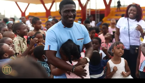 Dr Michael Boadi Nyamekye embraces children at the opening of The Maker’s House’s sensory unit