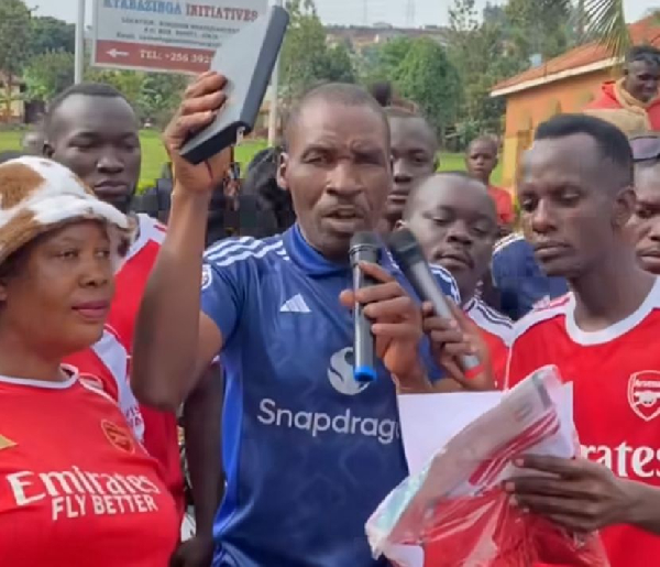 Kyemba holding a Bible during his