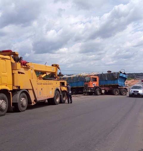 A tow truck waiting on the scene of the accident